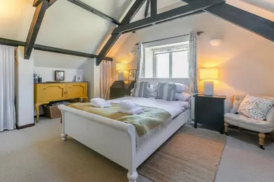 a bedroom with a large bed and a chair at 2 Bed in St. Martin oc-b33429 in Saint Martin