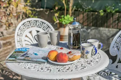 a table with a plate of fruit and coffee cups at 2 Bed in St. Martin oc-b33429 in Saint Martin