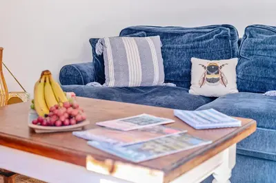 a coffee table with bananas and fruit on a blue couch at 2 Bed in St. Martin oc-b33430 in Saint Martin