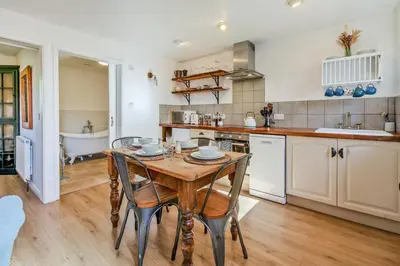 a kitchen with a table and chairs and a tub at 2 Bed in St. Martin oc-b33430 in Saint Martin