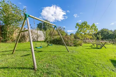an empty swing set in a grassy yard at 2 Bed in St. Martin oc-b33430 in Saint Martin