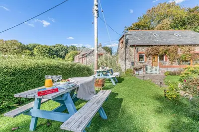 a picnic table in the garden atpendale cottage at 2 Bed in St. Martin oc-b33430 in Saint Martin