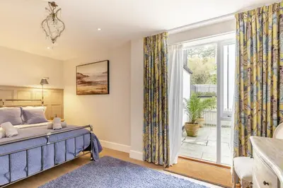 a bedroom with a bed and a large window at 2 Bed in Fowey oc-n33435 in Fowey