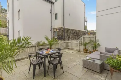 a patio with a table and chairs and a couch at 2 Bed in Fowey oc-n33435 in Fowey