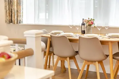 a dining room table with chairs and a table with wine glasses at 2 Bed in Fowey oc-n33435 in Fowey