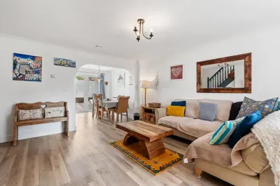 a living room with a couch and a table at Macalby Cottage in Padstow