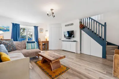 a living room with a couch and a table at Macalby Cottage in Padstow