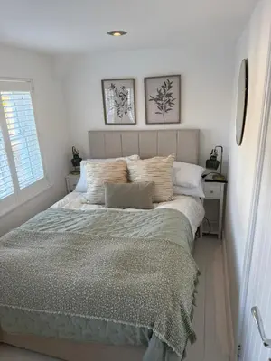 a bedroom with a bed and a window at Happy days cottage in St Ives