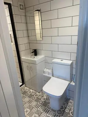 a bathroom with a white toilet and a sink at Happy days cottage in St Ives