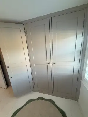 two white cabinets in a room with a rug at Happy days cottage in St Ives