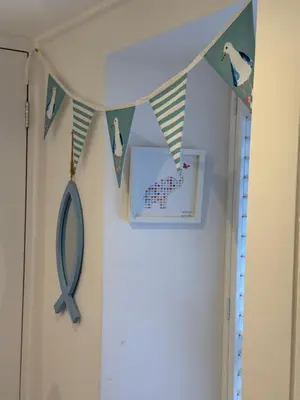 a hallway with a blue ribbon banner and a mirror at Happy days cottage in St Ives