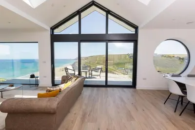 a living room with a couch and a table at Aurora Skies in Porthtowan