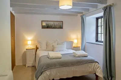 a bedroom with a bed with two towels on it at Finest Retreats - Rowella Cottage in Blisland