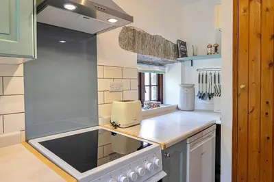 a kitchen with a sink and a stove top oven at Finest Retreats - Rowella Cottage in Blisland