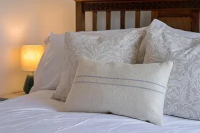 a white bed with white pillows on it at Finest Retreats - Demelza Cottage in Blisland