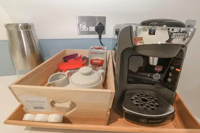 a wooden tray with a coffee maker and a mixer at The Black Barnacle in Redruth