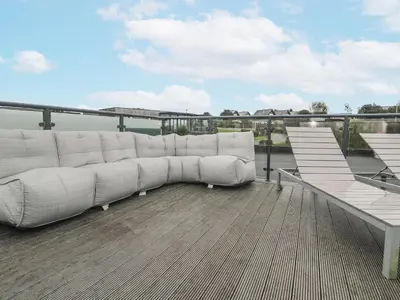 a white couch sitting on top of a roof at The Black Barnacle in Redruth