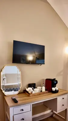 a room with a desk with a tv on the wall at Rising Sun Inn - Bronn Ewhella in Altarnun