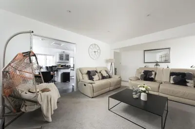 a living room with a couch and a table at Sunset View - Sea View - Pet Friendly - Free WiFi - Free Parking in Marazion