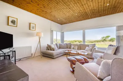 a living room with a couch and a table at 5 Bed in Trebetherick oc-t33296 in Polzeath