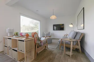 a living room with a bunk bed and a table at Penn Cottage perfect for North Cornwall trips in Camelford