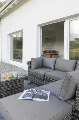 a living room with a couch and a table at Penn Cottage perfect for North Cornwall trips in Camelford