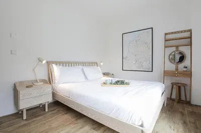 a bedroom with a white bed and a map on the wall at Penn Cottage perfect for North Cornwall trips in Camelford