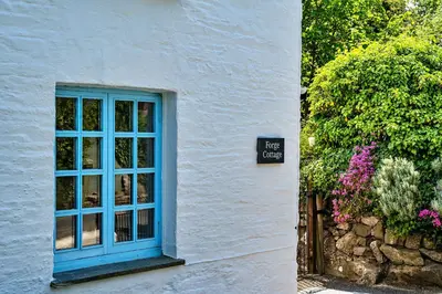 a blue window on the side of a building at Finest Retreats - Forge Cottage, Padstow in Padstow