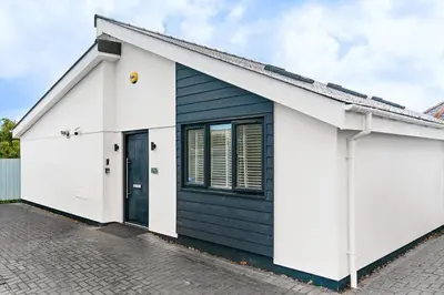 a house with a black and white facade at Kimberley Cottage - Stylish cottage & parking in Falmouth
