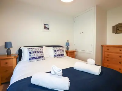 a bedroom with a bed with towels on it at 3 The Old Cornstore in St. Agnes