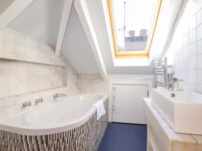 a bathroom with a large tub and a sink at 3 The Old Cornstore in St. Agnes