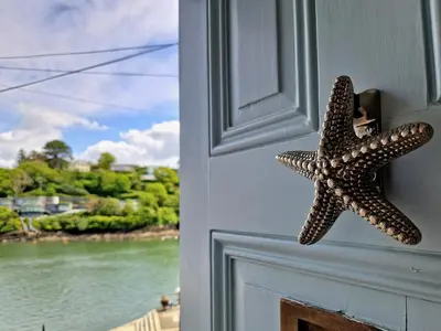 a starfish hanging on the door of a house at The Bolthole in Fowey