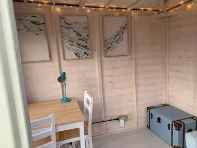 a small room with a table and a desk with a desk at The Bolthole in Fowey