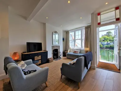 a living room with two couches and a tv at The Bolthole in Fowey