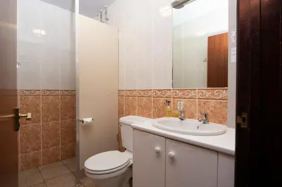 a bathroom with a toilet and a sink and a mirror at Tricky's at The Tolgus Inn, Redruth - Free WiFi - Free Parking in Redruth
