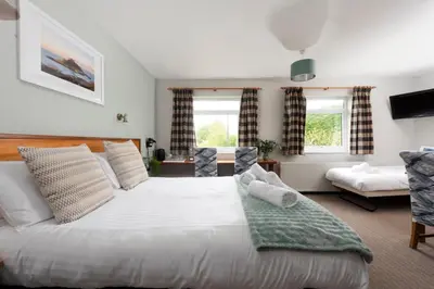 a bedroom with a large white bed in a room at Tricky's at The Tolgus Inn, Redruth - Free WiFi - Free Parking in Redruth