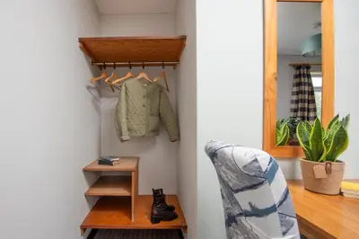 a room with a shelf and a chair and a mirror at Tricky's at The Tolgus Inn, Redruth - Free WiFi - Free Parking in Redruth