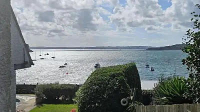 a view of a large body of water with boats in it at The Red House Annexe in Saint Mawes