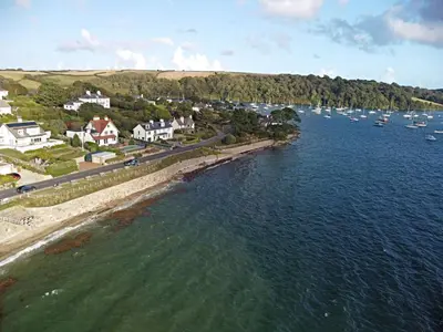 an aerial view of a body of water with boats at The Red House Annexe in Saint Mawes