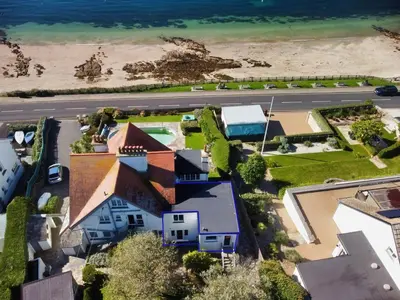 an aerial view of a house and the beach at The Red House Annexe in Saint Mawes