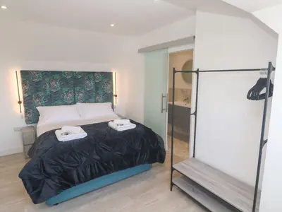 a bedroom with a bed with two towels on it at Shearwater in Penzance