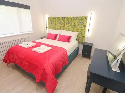 a bedroom with a bed with two towels on it at Shearwater in Penzance