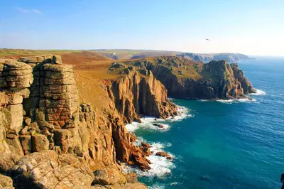 an aerial view of the ocean and a rocky coast at Landal Clowance in Crowan