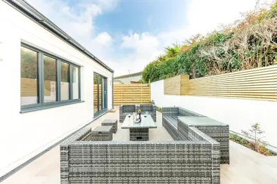an outdoor patio with a table and chairs at 5 Bed in St. Ives oc-c28961 in Saint Ewe