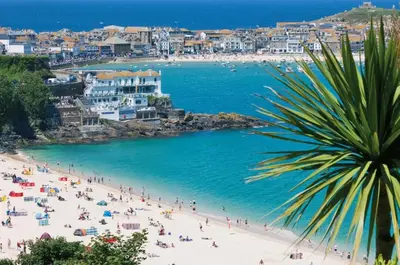 a beach with a crowd of people and the ocean at 5 Bed in St. Ives oc-c28961 in Saint Ewe