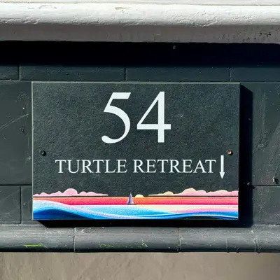 a sign that reads turtle retrieval on a parking meter at Turtle retreat in Falmouth