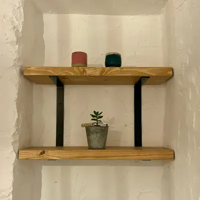 a wooden shelf with a plant on a wall at Turtle retreat in Falmouth