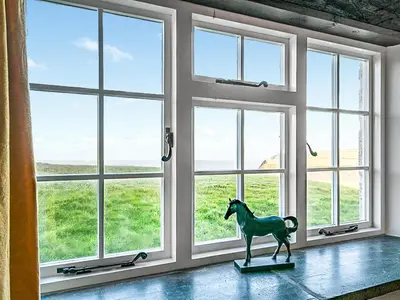a statue of a horse in front of a window at Wharrastone - Uk50661 in Bude