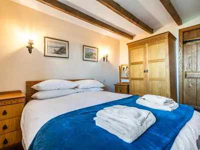 a bedroom with a bed with towels on it at Wharrastone - Uk50661 in Bude