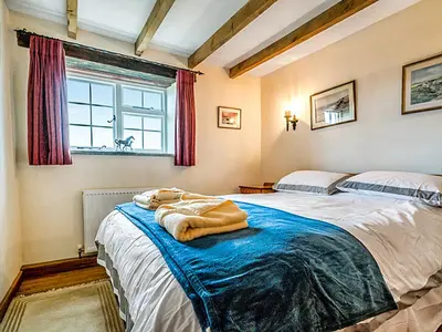 a bedroom with two beds and a window at Wharrastone - Uk50661 in Bude